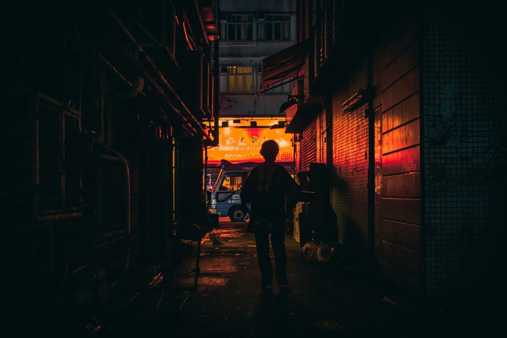 silhouette photo of person walking in alley 3029352