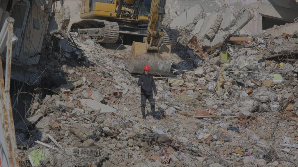 man walking among urban ruins