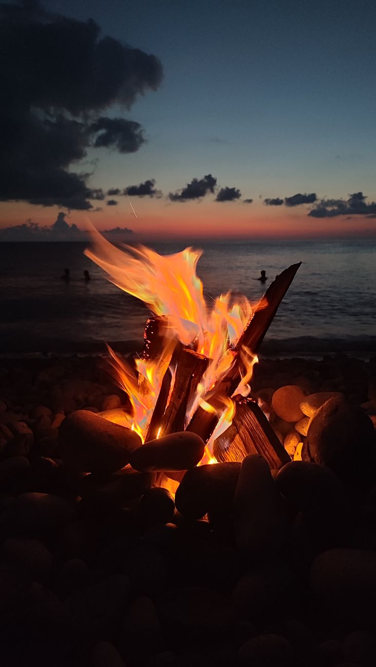 cozy beach bonfire at sunset