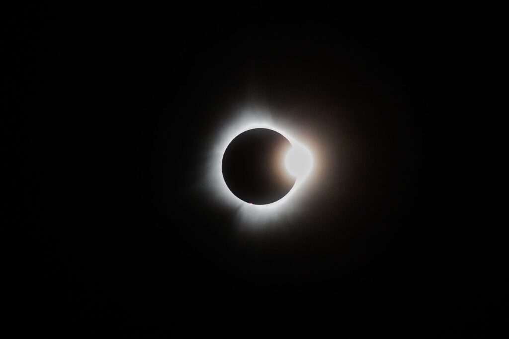 sunlight behind moon in space
